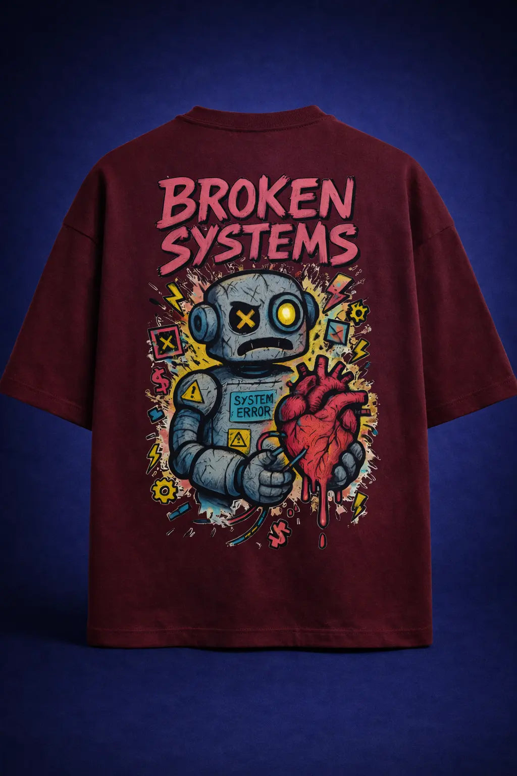Maroon oversized t-shirt with bold "Broken Systems" text and robot holding a heart graphic on back, colorful streetwear design, edgy aesthetic