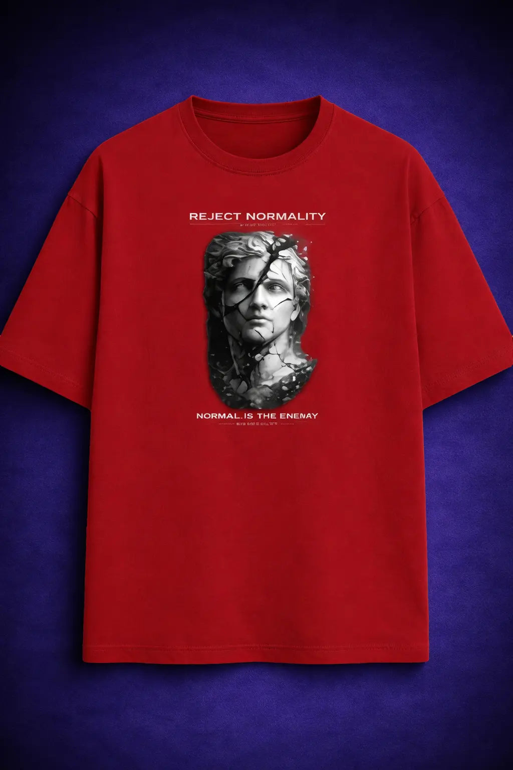 Red oversized t shirt with cracked statue graphic and “Reject Normality” text – Maxedoutt streetwear